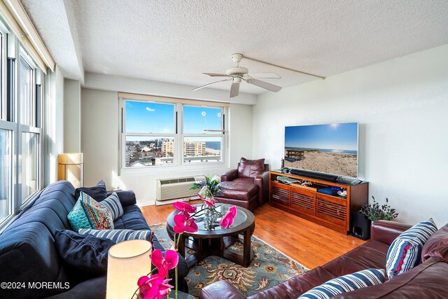 living room with ceiling fan, a wealth of natural light, and hardwood / wood-style flooring