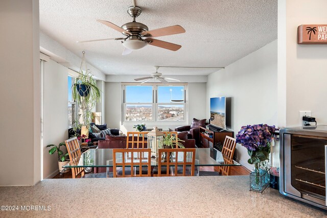 living room with a textured ceiling and ceiling fan