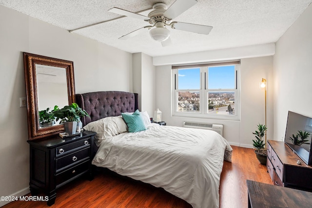 bedroom with ceiling fan, a textured ceiling, and wood-type flooring