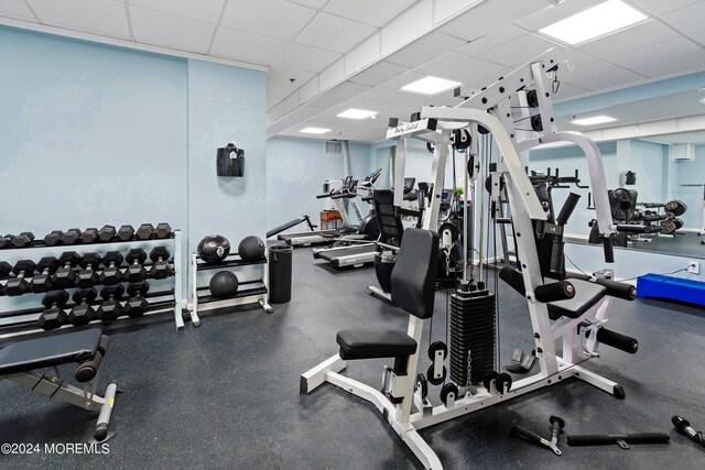 exercise room with a paneled ceiling