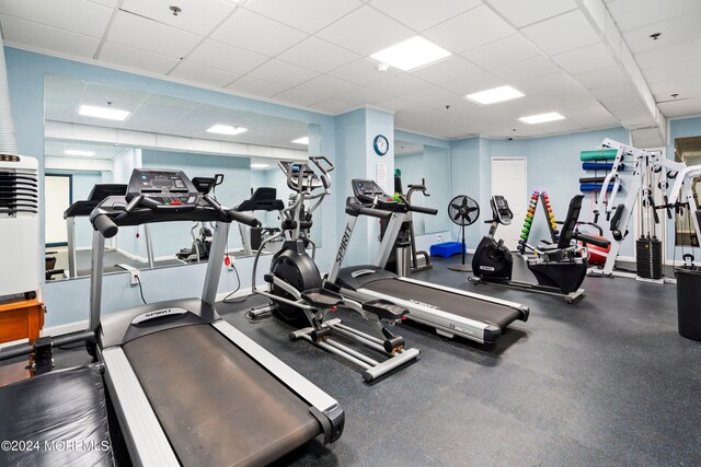 workout area featuring a paneled ceiling