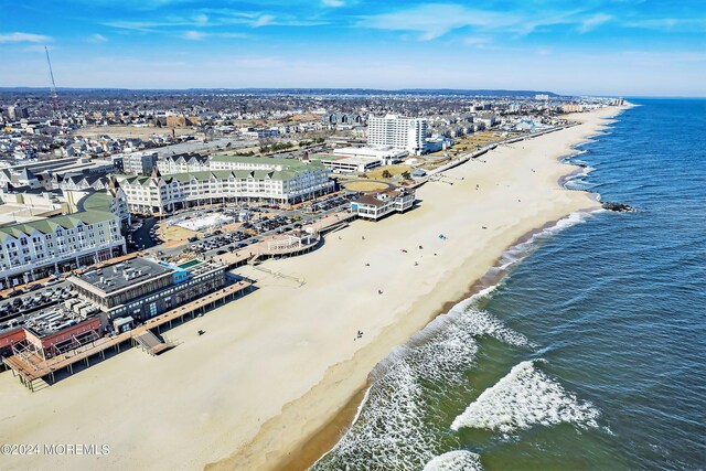 drone / aerial view with a view of the beach and a water view