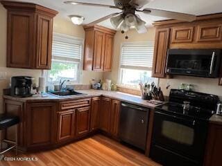 kitchen with light hardwood / wood-style flooring, sink, ceiling fan, dishwasher, and black / electric stove