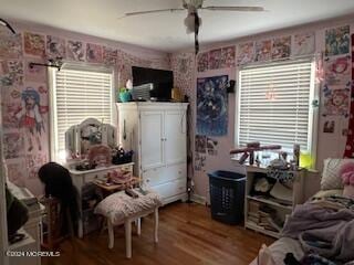 bedroom with hardwood / wood-style floors and ceiling fan