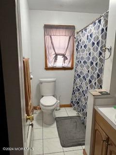 bathroom featuring toilet, vanity, and tile patterned flooring