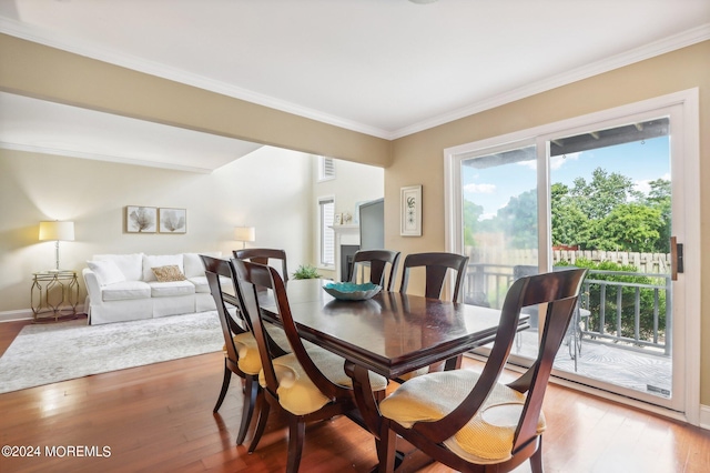 dining area featuring hardwood / wood-style flooring and crown molding