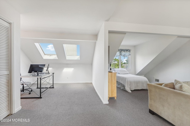 carpeted bedroom with lofted ceiling