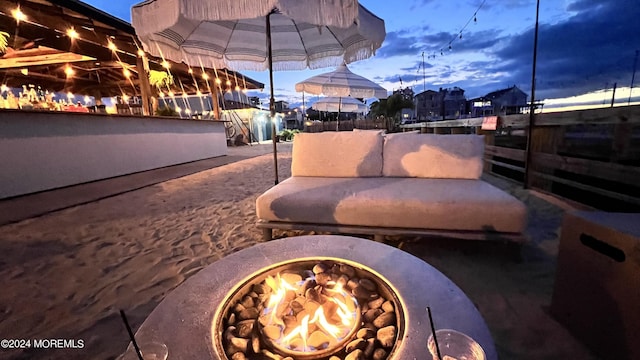 patio terrace at dusk with an outdoor fire pit