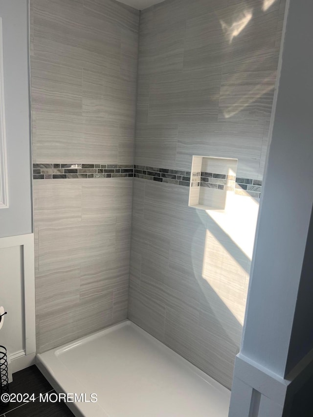 bathroom with a tile shower