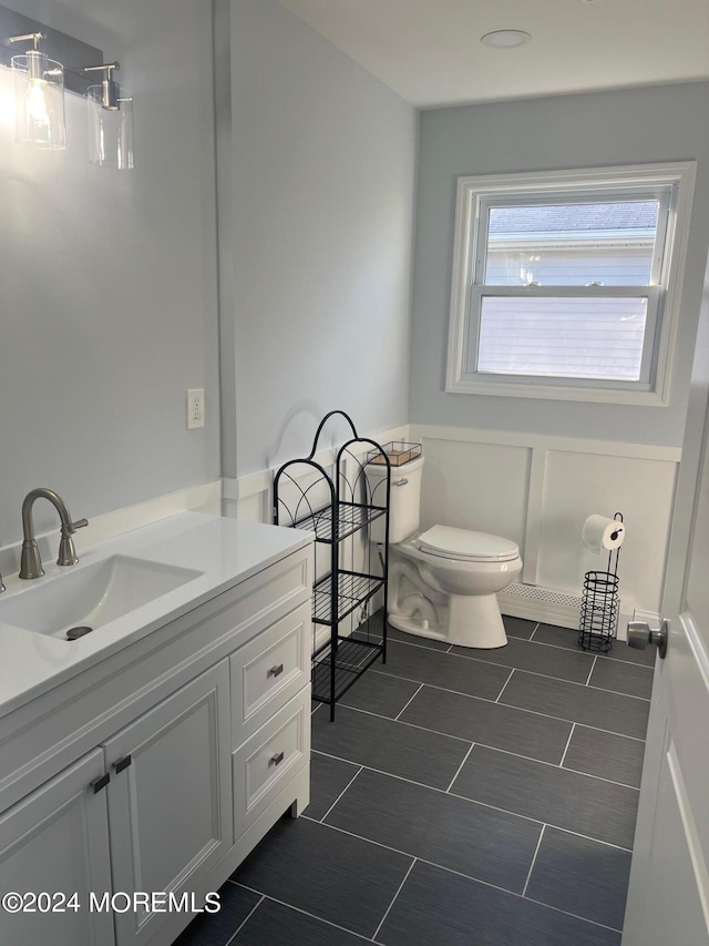 bathroom featuring vanity and toilet