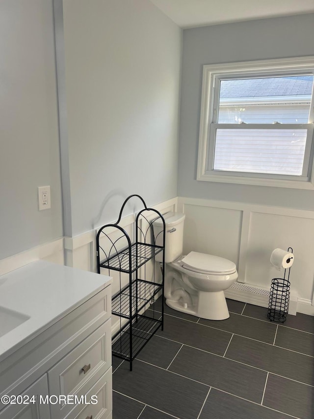 bathroom with tile patterned flooring, vanity, and toilet