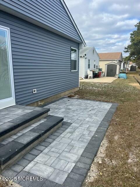 view of patio featuring a storage shed