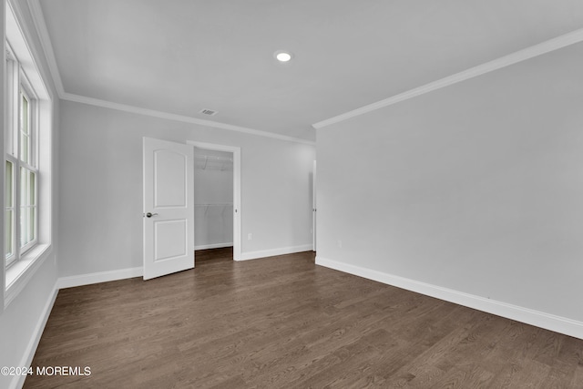 unfurnished room featuring crown molding and dark hardwood / wood-style floors