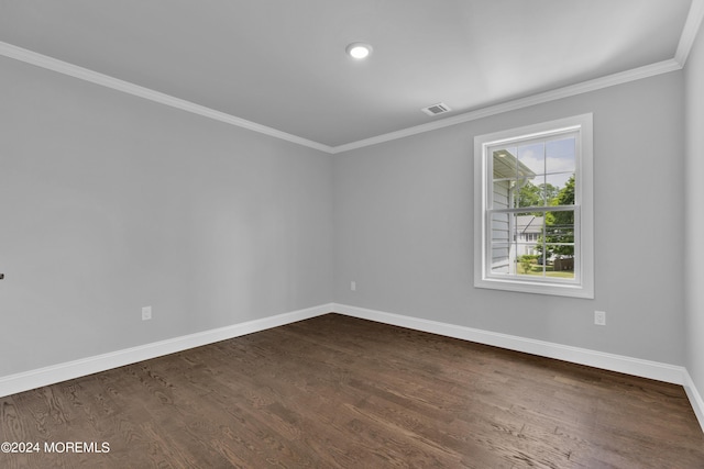 spare room with dark hardwood / wood-style flooring and ornamental molding