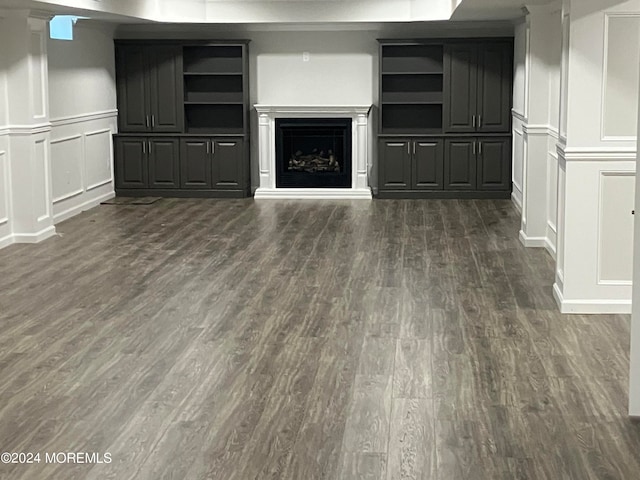 unfurnished living room featuring dark hardwood / wood-style flooring