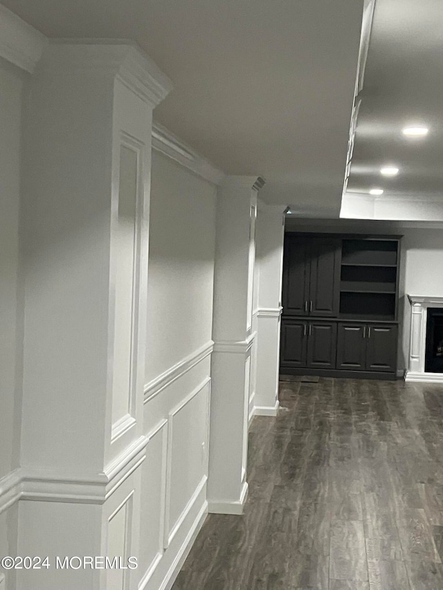 hallway featuring dark hardwood / wood-style floors and ornamental molding