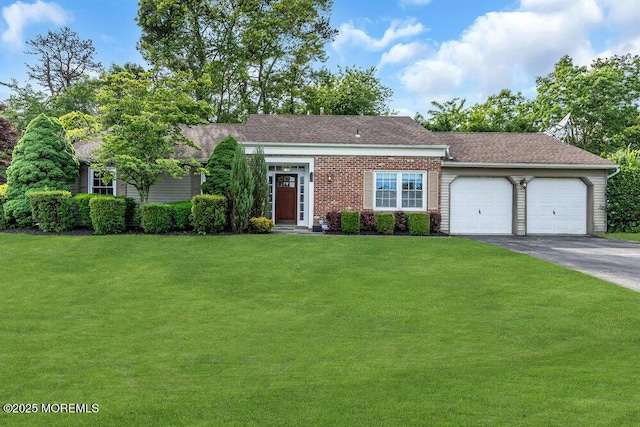 view of front of home featuring asphalt driveway, an attached garage, a front lawn, and a shingled roof