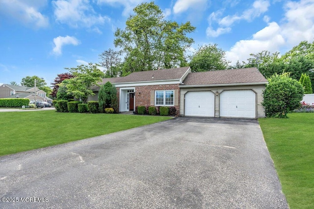ranch-style house featuring a garage, a front yard, driveway, and brick siding