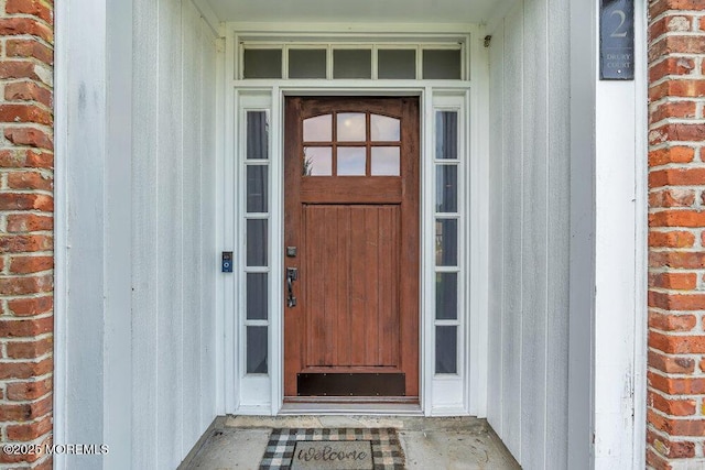 doorway to property with brick siding