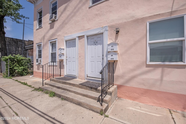 entrance to property featuring cooling unit