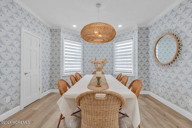 dining space with plenty of natural light, ornamental molding, and light wood-type flooring