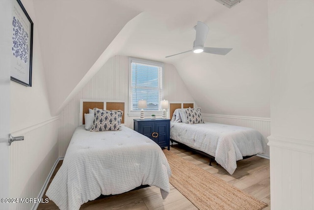 bedroom featuring lofted ceiling, ceiling fan, and light wood-type flooring