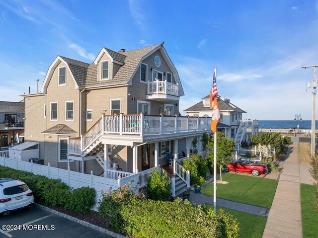 view of front facade with covered porch and a balcony