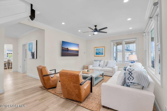 living room with crown molding, ceiling fan, and light hardwood / wood-style floors