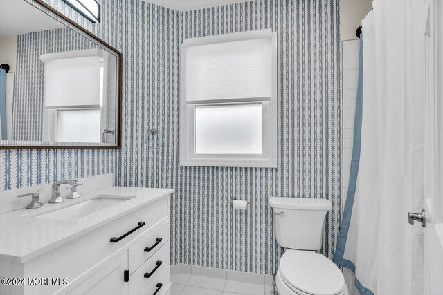 bathroom with vanity, curtained shower, tile patterned floors, and toilet