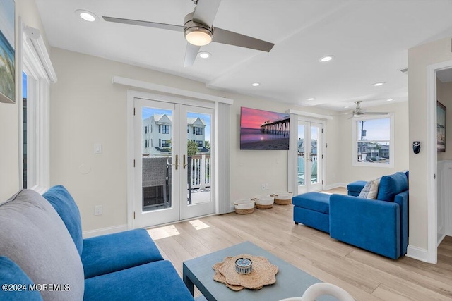 living room featuring ceiling fan, light hardwood / wood-style floors, and french doors