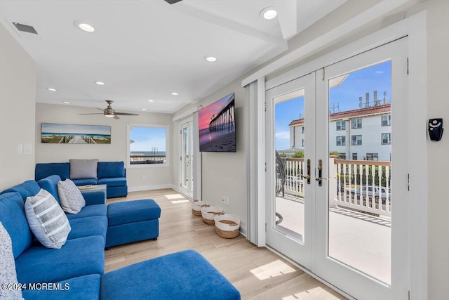 living room with light hardwood / wood-style flooring, french doors, and ceiling fan