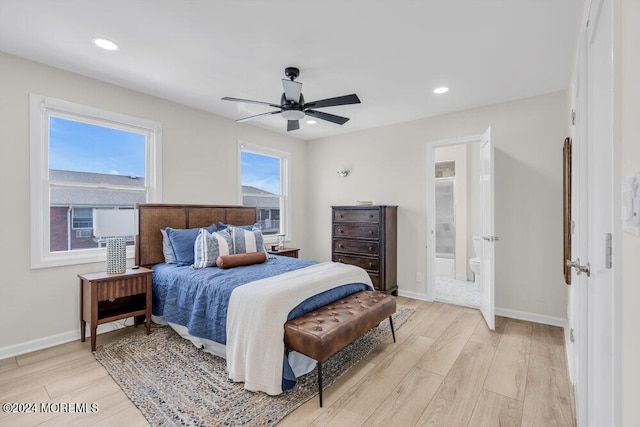 bedroom with ensuite bath, light hardwood / wood-style flooring, and ceiling fan