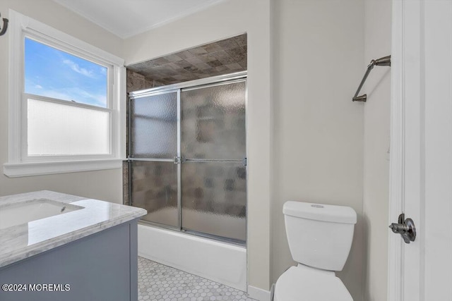 full bathroom featuring vanity, combined bath / shower with glass door, and toilet