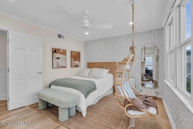 bedroom featuring crown molding, ceiling fan, and hardwood / wood-style flooring