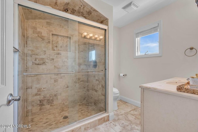 bathroom featuring vanity, an enclosed shower, and toilet