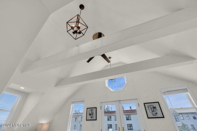 interior details featuring beamed ceiling, a chandelier, and french doors