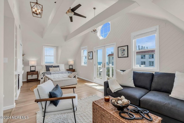 living room featuring high vaulted ceiling, a notable chandelier, light hardwood / wood-style floors, french doors, and beamed ceiling