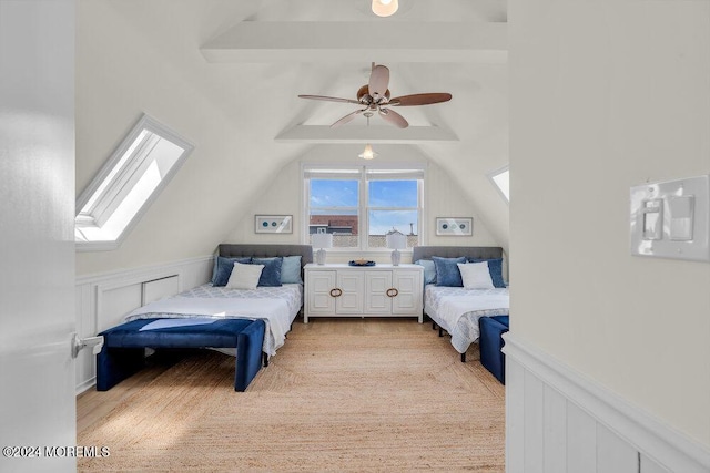 bedroom featuring ceiling fan, vaulted ceiling with skylight, and light wood-type flooring