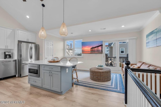 kitchen featuring gray cabinets, appliances with stainless steel finishes, a kitchen island, pendant lighting, and white cabinetry