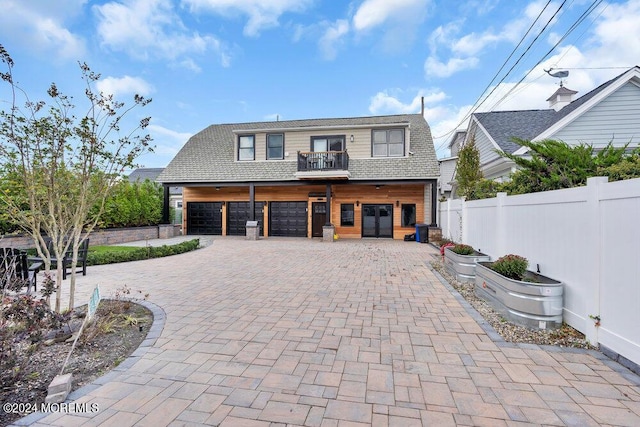 view of front facade featuring a garage and a balcony