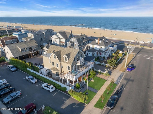 drone / aerial view featuring a view of the beach and a water view