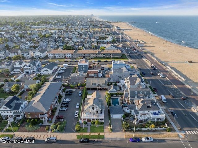 aerial view with a water view and a beach view