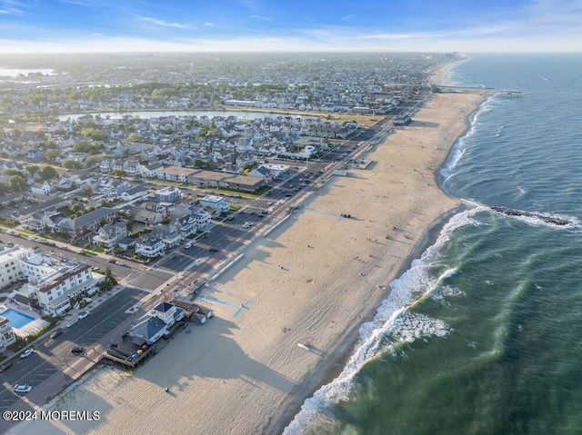 bird's eye view featuring a water view and a view of the beach