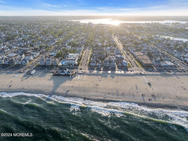 birds eye view of property featuring a beach view and a water view