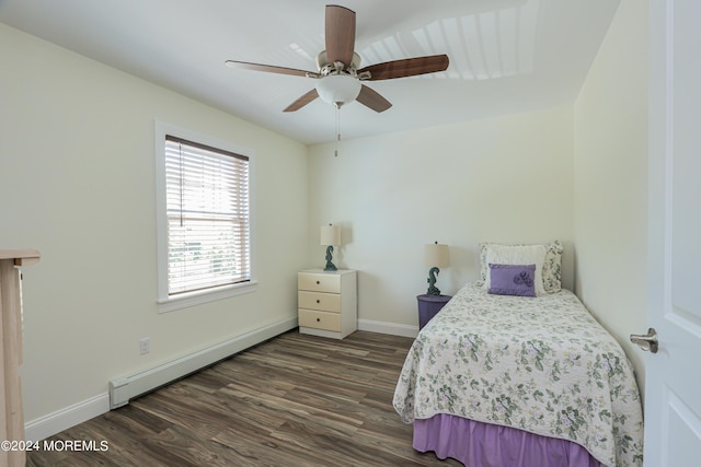 bedroom featuring dark hardwood / wood-style flooring, baseboard heating, and ceiling fan