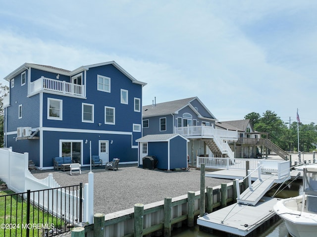 rear view of house featuring an outdoor hangout area, a shed, and a wooden deck