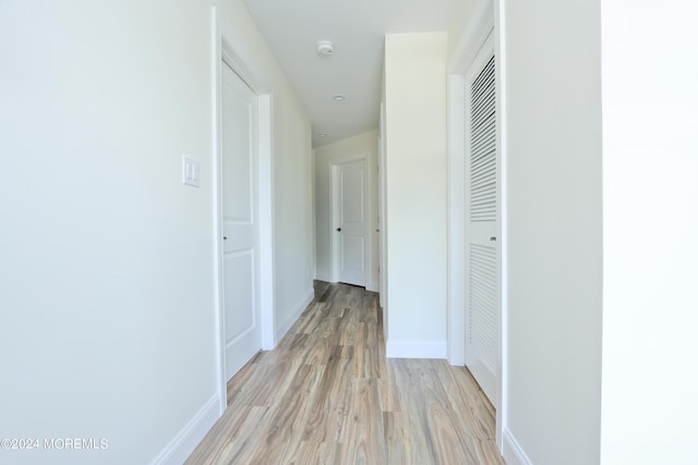 corridor with light hardwood / wood-style floors