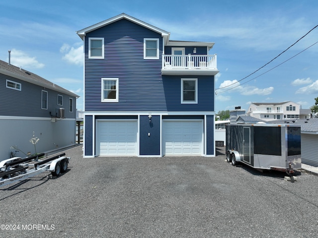 exterior space with a balcony and a garage