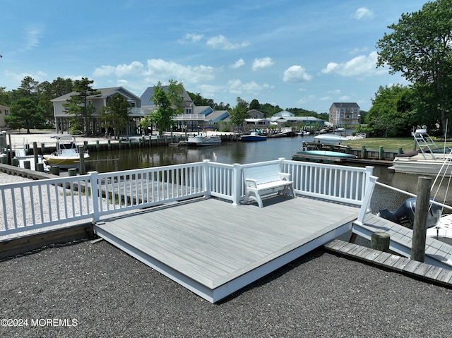 view of dock with a deck with water view