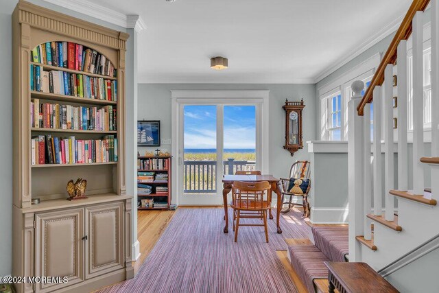 dining room with light hardwood / wood-style floors and ornamental molding